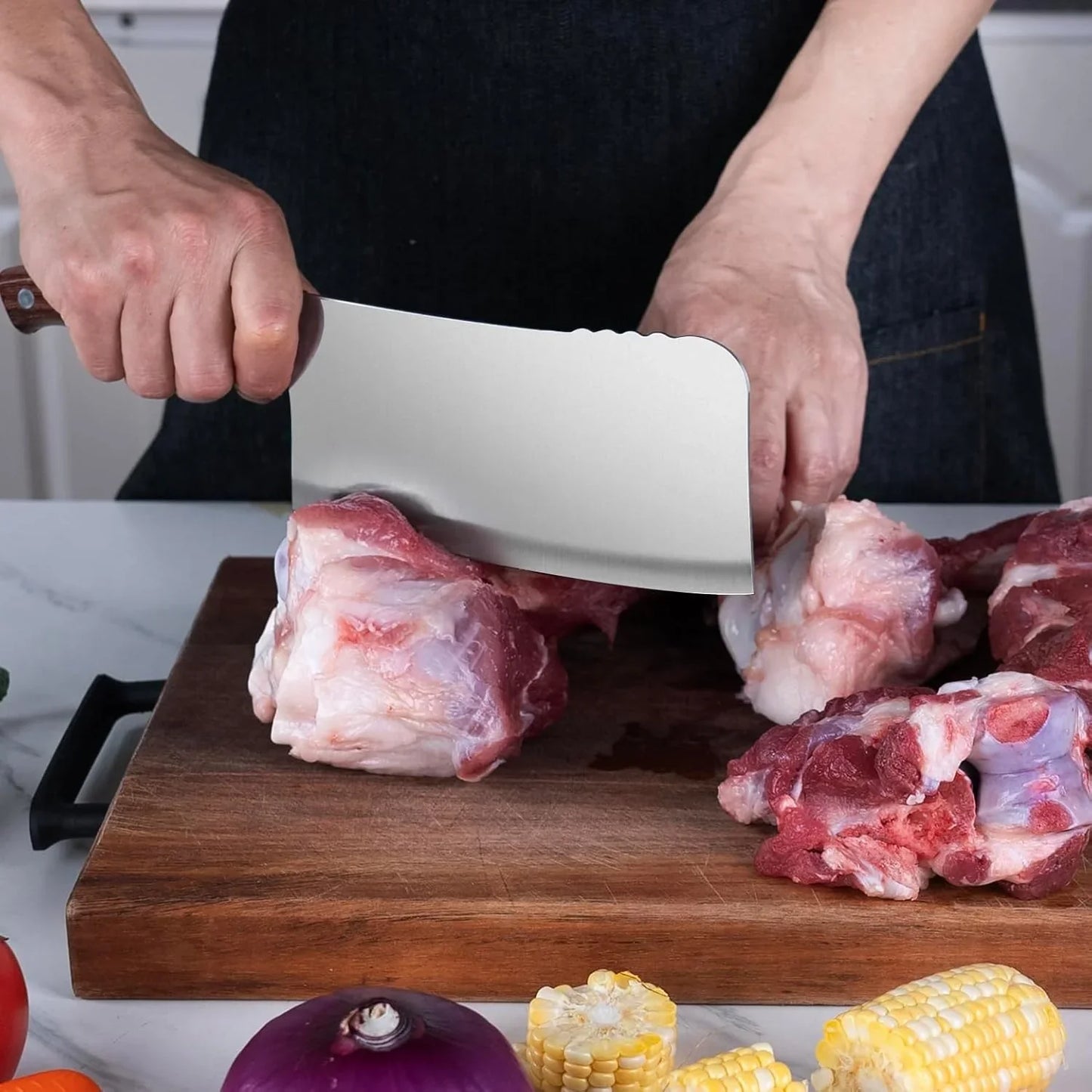 Person using 7-inch heavy-duty meat cleaver to chop raw meat on wooden cutting board