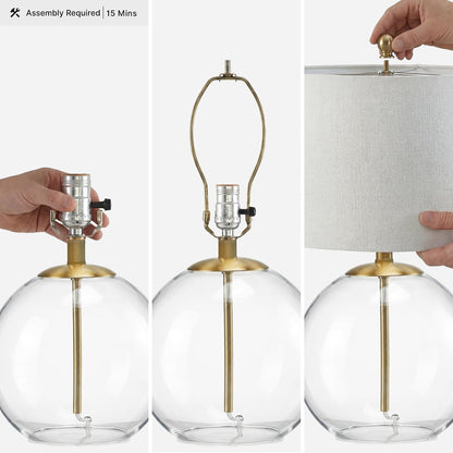 Signature Design by Ashley Glass Table Lamp, Modern Bedside, Clear & Brass | White Fabric Drum Shade, Compact round Clear Glass Profile for Modern Nightstands, Samder Series3