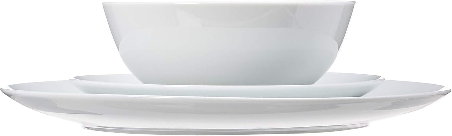Stack of 10.5 inch white porcelain coupe dinner plates for everyday use.