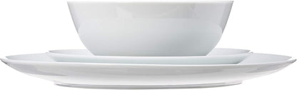 Stack of 10.5 inch white porcelain coupe dinner plates for everyday use.
