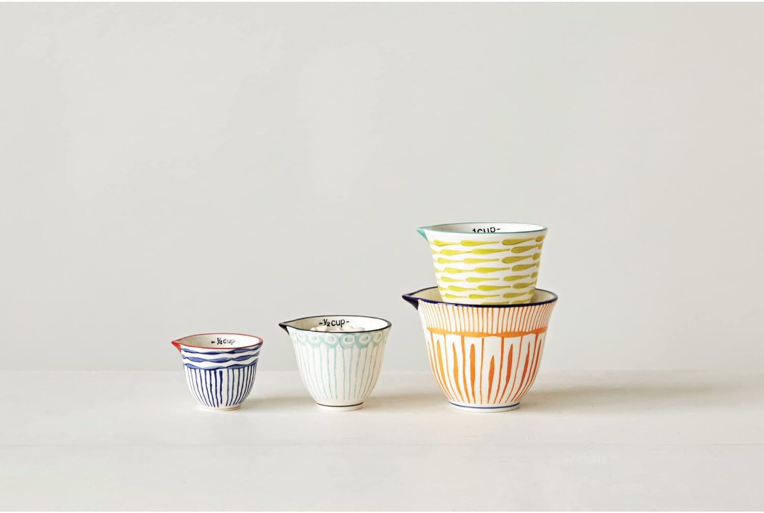 creative-co-op-4-piece-hand-painted-stoneware-measuring-cups-with-patterns-and-colored-rims-multicolor