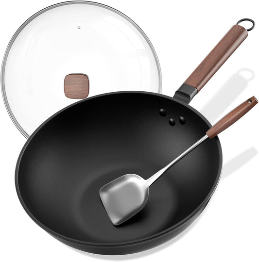Black wok with wooden handle and lid, accompanied by a silver spatula on a white background