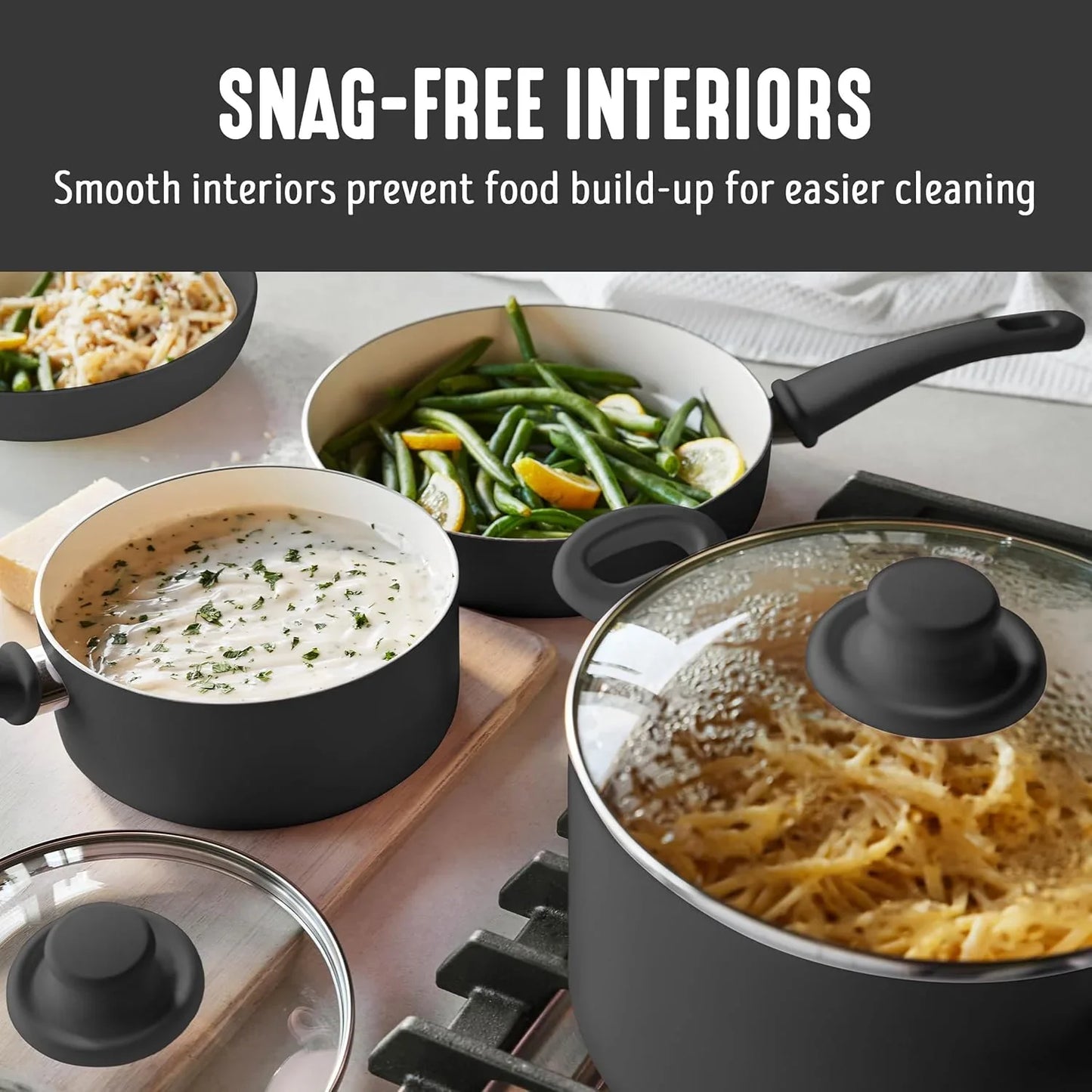 Black and cream ceramic nonstick cookware set cooking pasta and green beans with glass lids
