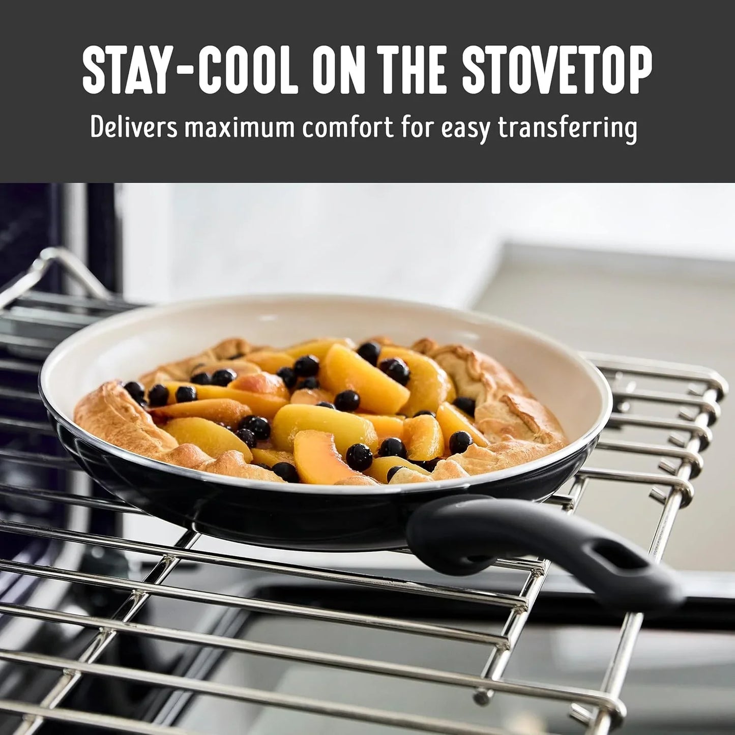 Nonstick ceramic frying pan on stove with peach and blueberry dessert inside