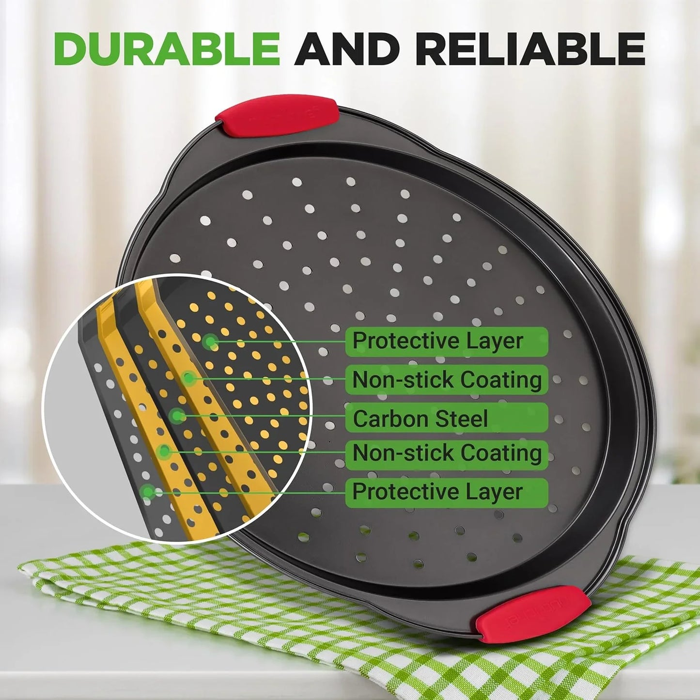 13-inch black nonstick perforated pizza pan with red silicone handles on green checkered cloth