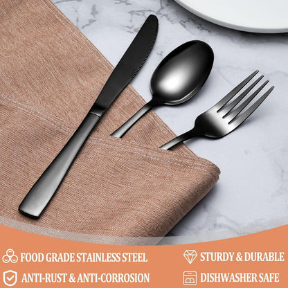 Black stainless steel knife, spoon, and fork in textured brown napkin on marble surface