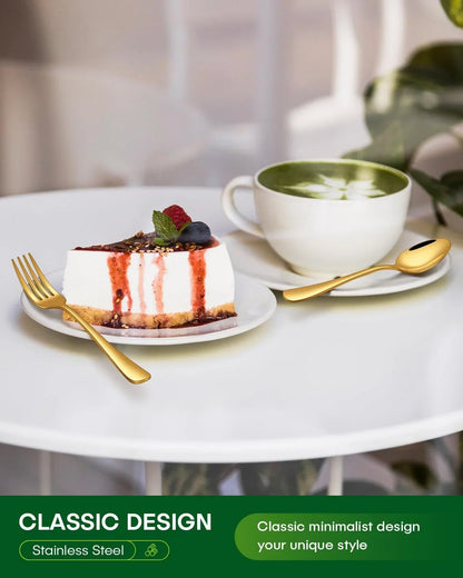 Gold stainless steel fork and spoon on white table with cheesecake and green tea latte