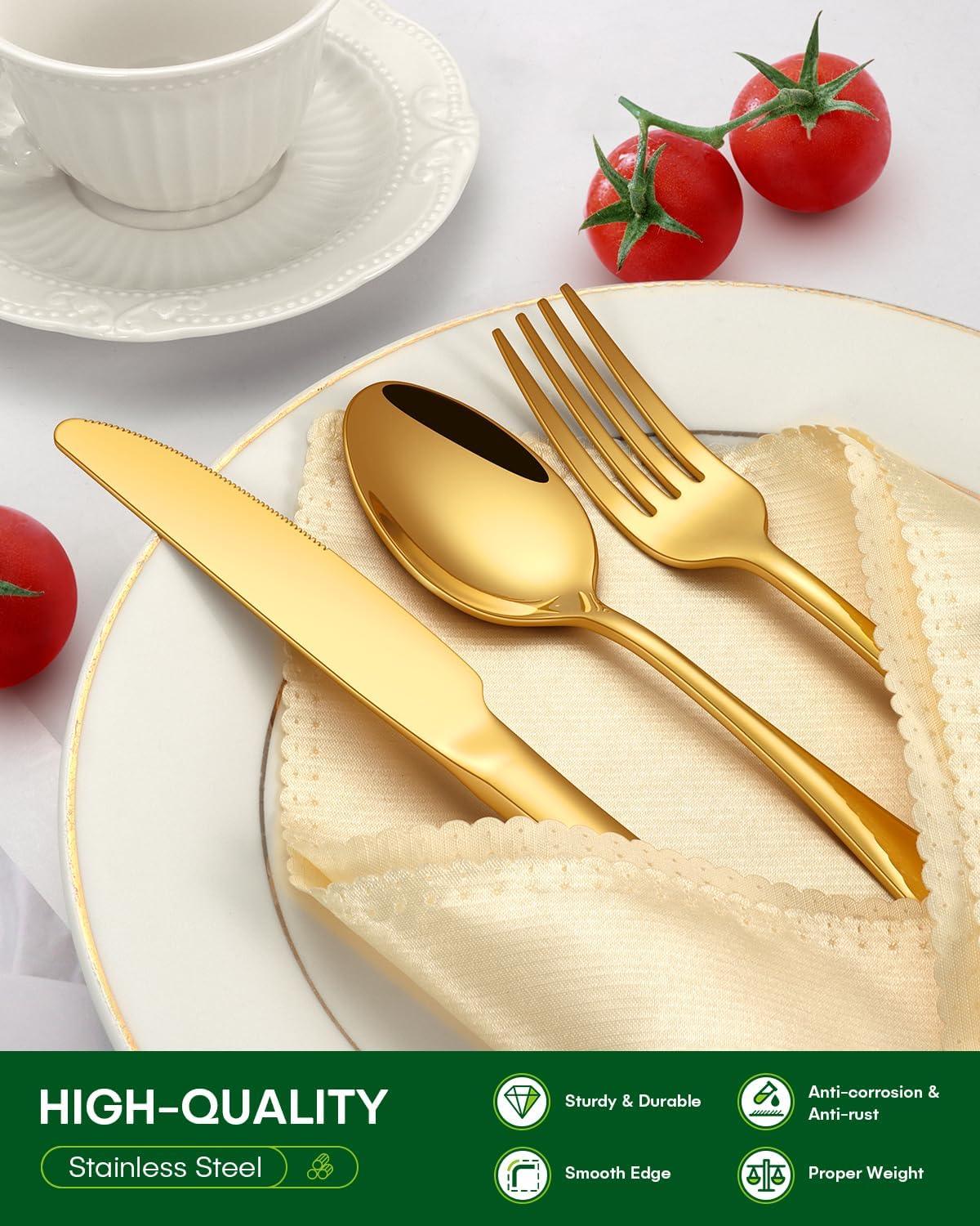 Gold stainless steel knife, spoon, and fork set on cream napkin and white plate with tomatoes and teacup