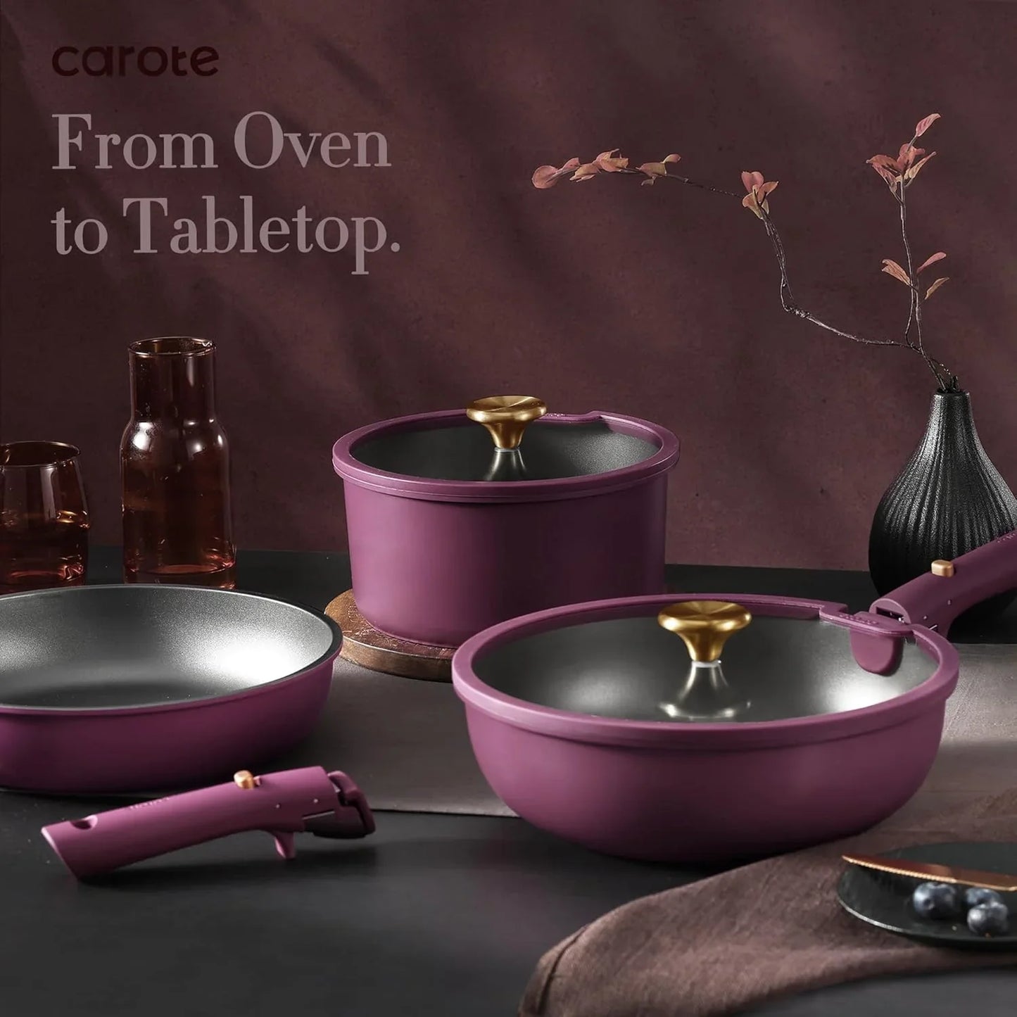 21-piece nonstick purple and gold pots and pans set with detachable handle on dark tabletop