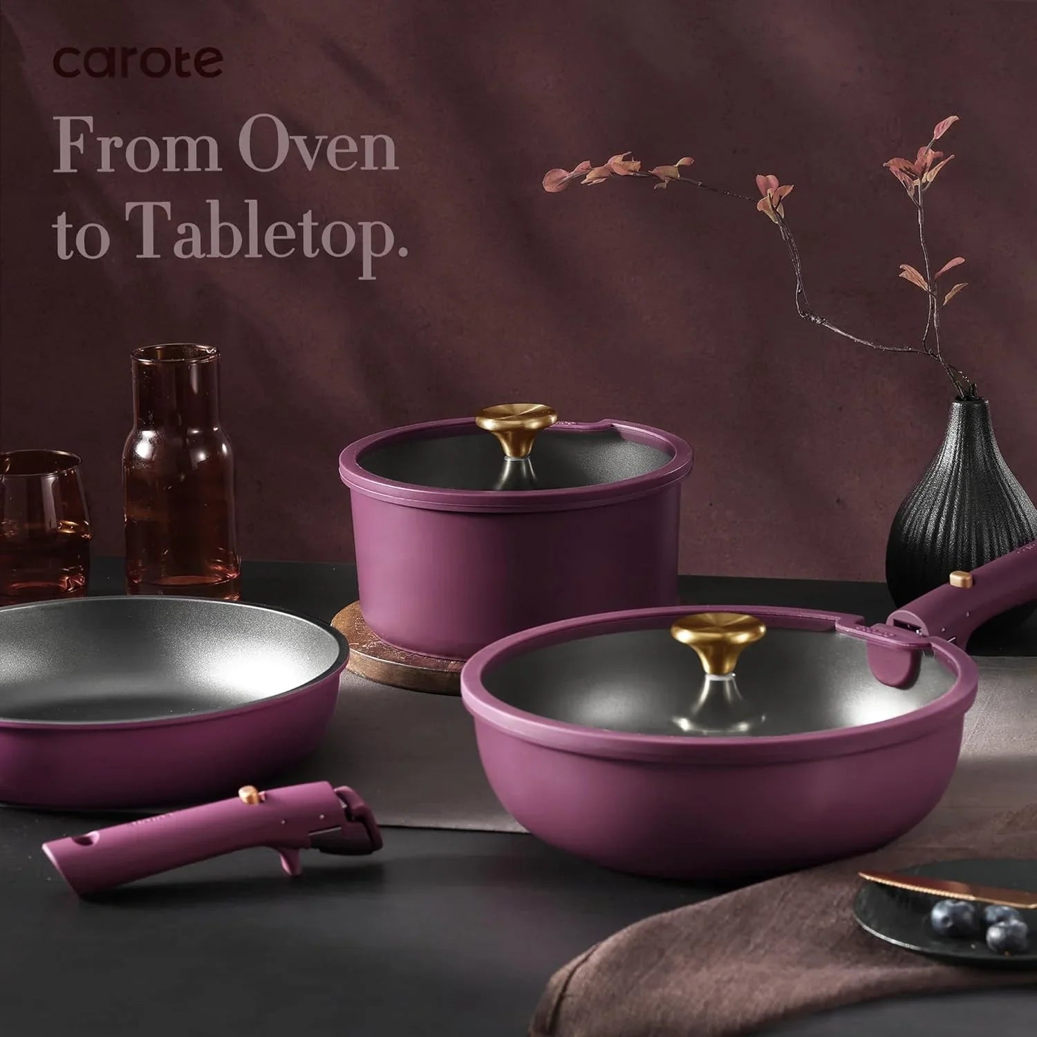 21-piece nonstick purple and gold pots and pans set with detachable handle on dark tabletop
