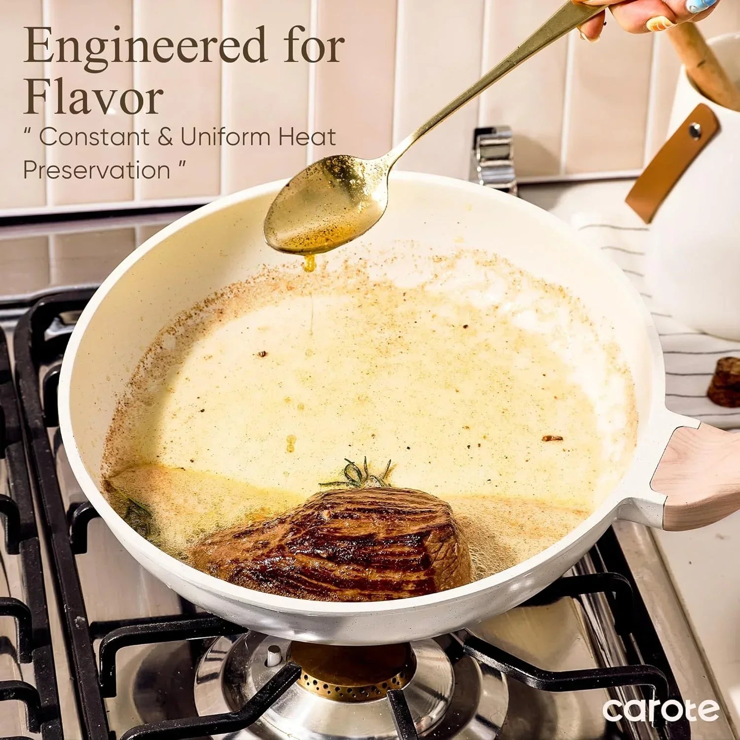 White granite nonstick frying pan on gas stove cooking seared steak with rosemary and sauce