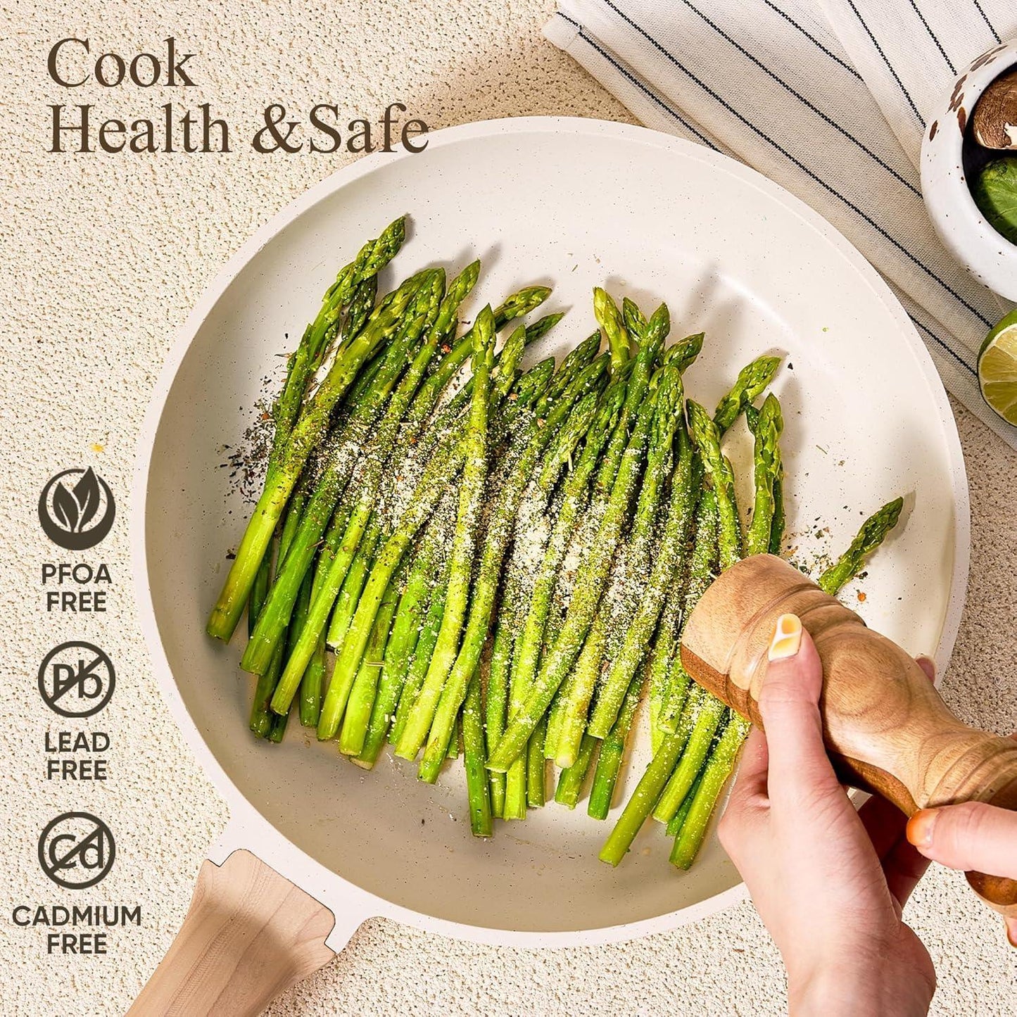 White granite frying pan with cooked asparagus being seasoned with pepper, healthy nonstick cookware
