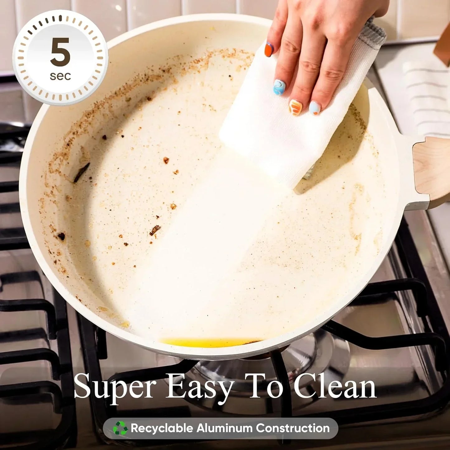 Hand wiping white nonstick frying pan on gas stove, showing easy cleaning in 5 seconds