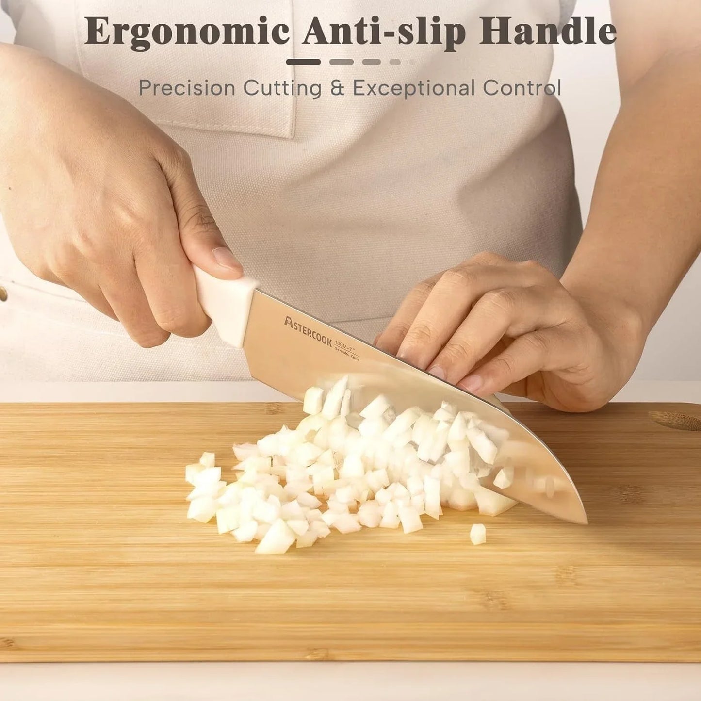 Hands using cream white AsterCook Santoku knife to dice onion on bamboo cutting board