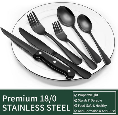 24-piece black stainless steel flatware set including steak knives on white plate