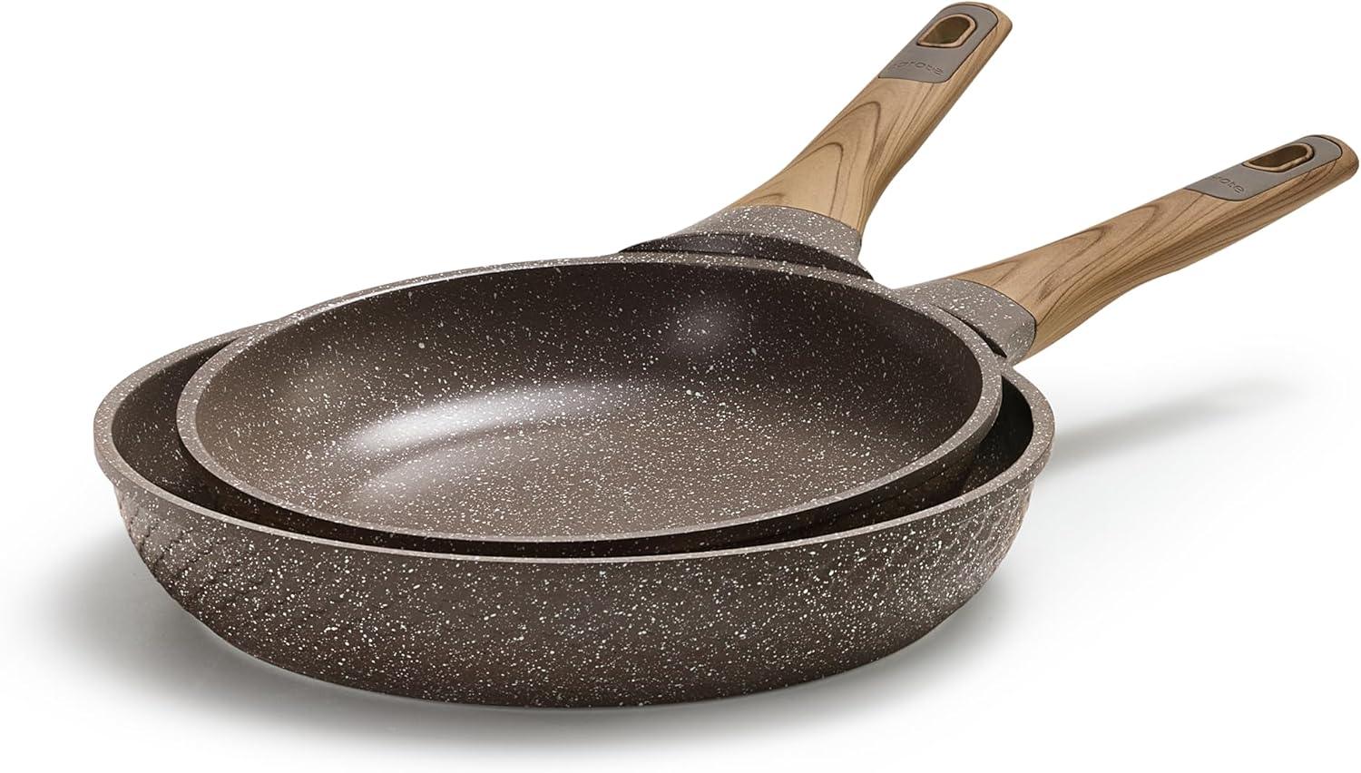 Two stacked brown granite nonstick frying pans with wooden handles on white background