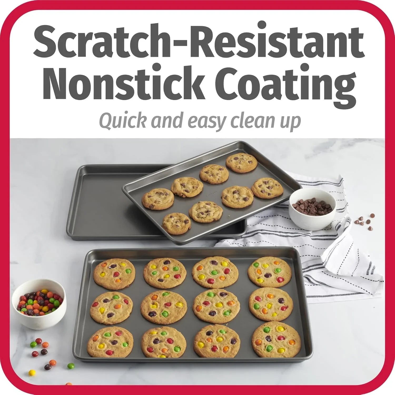 Three carbon steel nonstick baking sheets with freshly baked cookies featuring candy and chocolate chips on a marble countertop