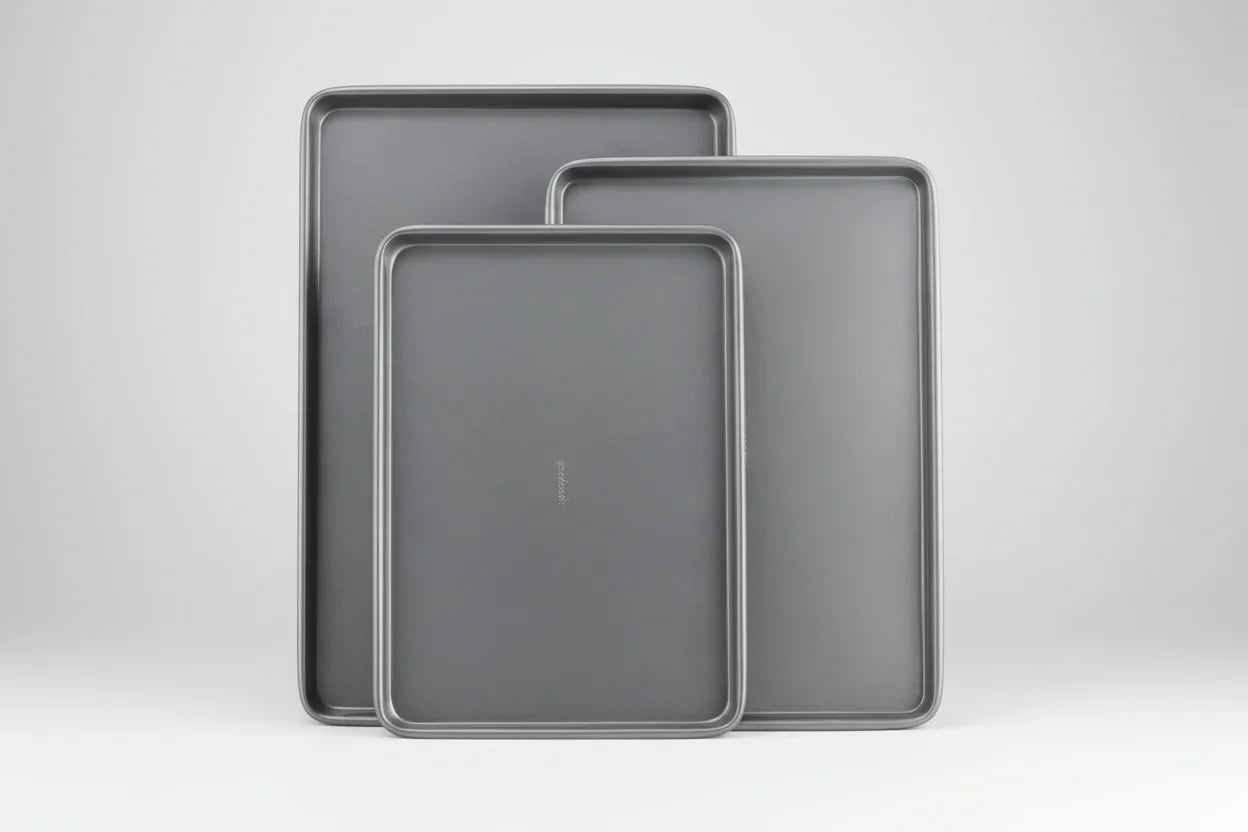 Set of three nested gray nonstick carbon steel baking sheets in small, medium, and large sizes