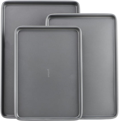 Three nonstick carbon steel baking sheets in small, medium and large sizes stacked together.