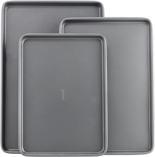 Three nonstick carbon steel baking sheets in small, medium and large sizes stacked together.