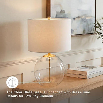 Signature Design by Ashley Glass Table Lamp, Modern Bedside, Clear & Brass | White Fabric Drum Shade, Compact round Clear Glass Profile for Modern Nightstands, Samder Series4