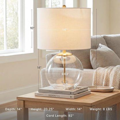 Signature Design by Ashley Glass Table Lamp, Modern Bedside, Clear & Brass | White Fabric Drum Shade, Compact round Clear Glass Profile for Modern Nightstands, Samder Series2