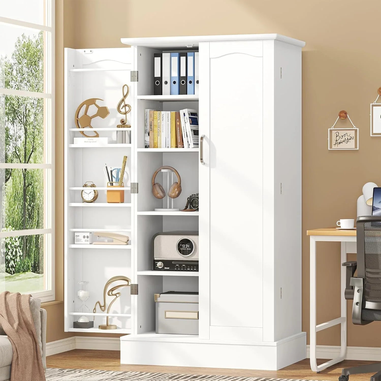 White freestanding pantry cabinet with adjustable shelves holding books, headphones, radio, and office supplies