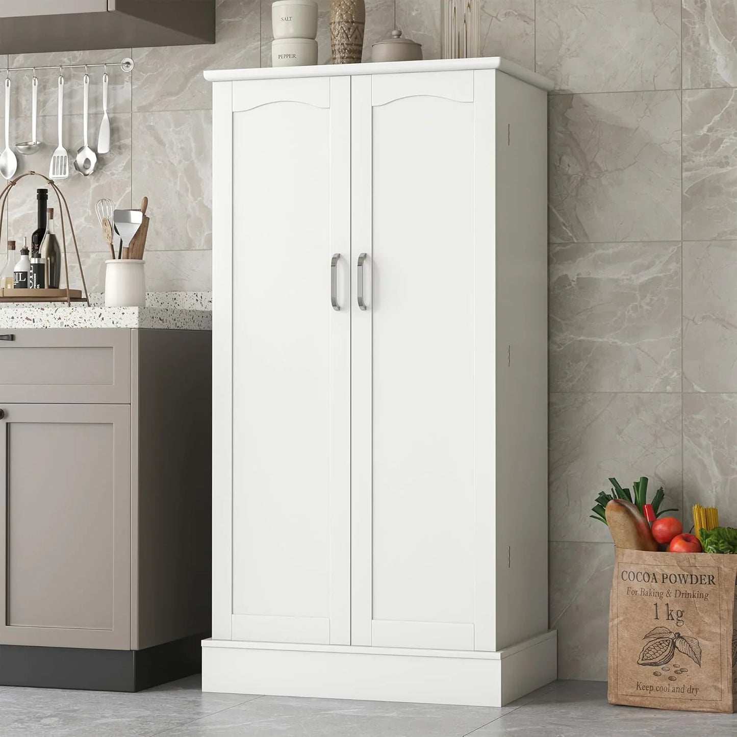 White freestanding pantry cabinet with two doors and silver handles in modern kitchen setting