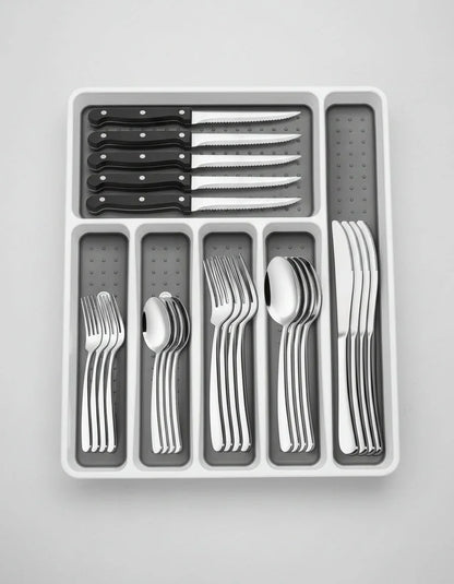49-piece stainless steel silverware set with black-handled steak knives in white organizer tray