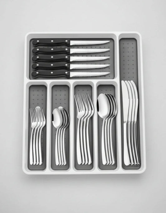 49-piece stainless steel silverware set with black-handled steak knives in white organizer tray