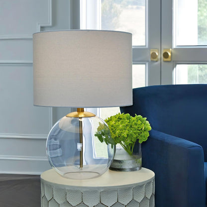 Signature Design by Ashley Glass Table Lamp, Modern Bedside, Clear & Brass | White Fabric Drum Shade, Compact round Clear Glass Profile for Modern Nightstands, Samder Series10
