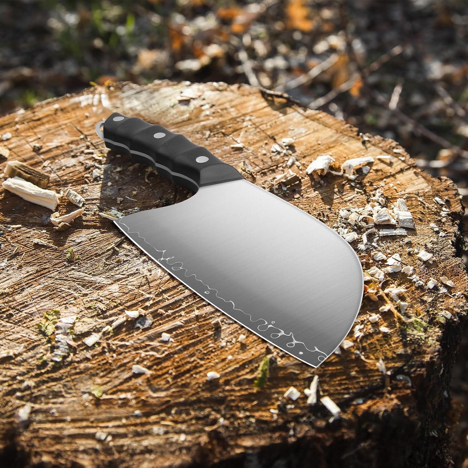 Japanese high carbon steel meat cleaver with black handle on tree stump outdoors