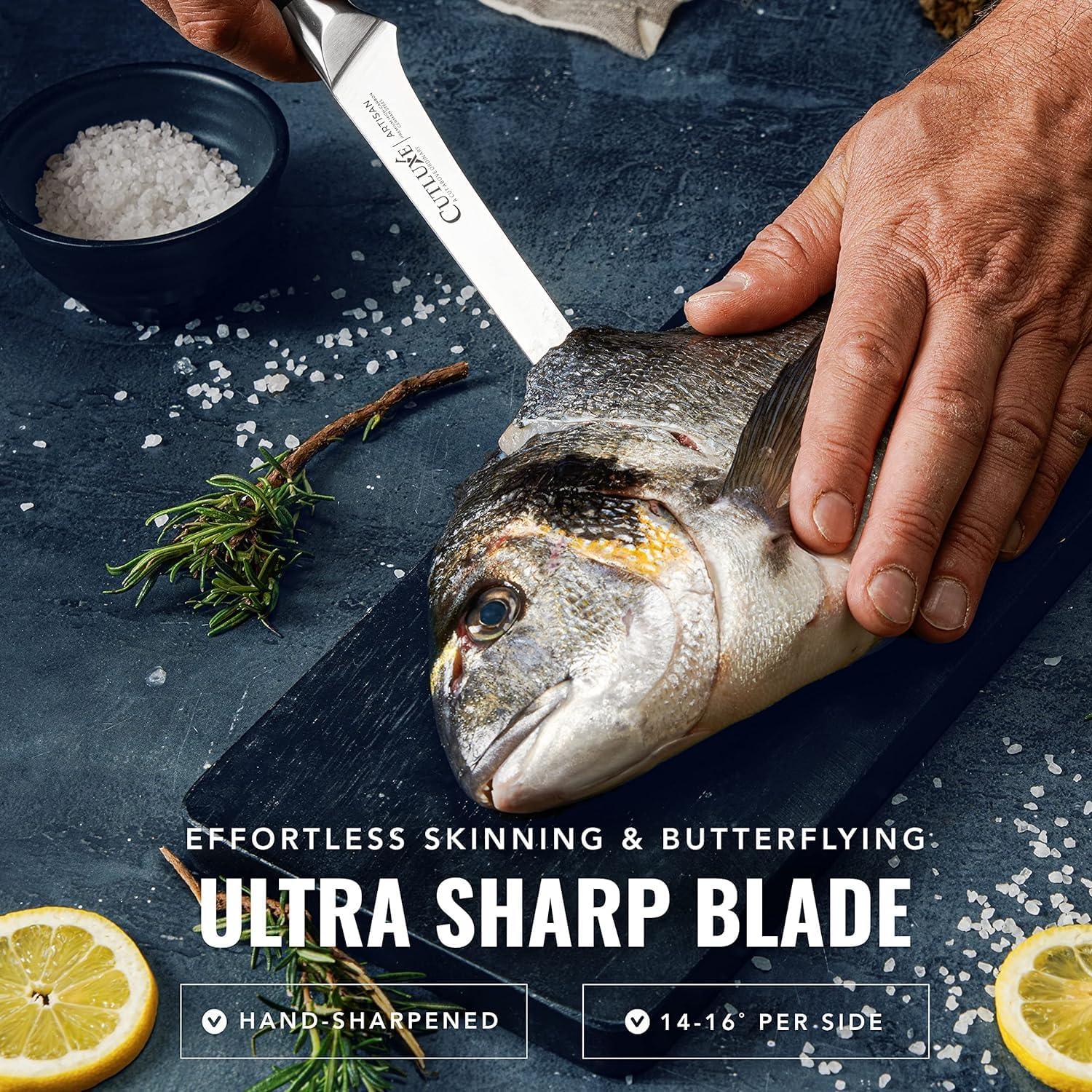 6-inch razor sharp boning knife by Cutluxe slicing fish on cutting board with salt, lemon, and herbs