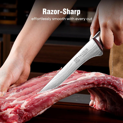 Hand holding a razor-sharp PAUDIN boning knife cutting raw pork ribs on wooden surface