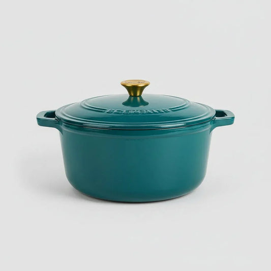 6-quart emerald green enameled cast iron Dutch oven with gold knob lid on white background