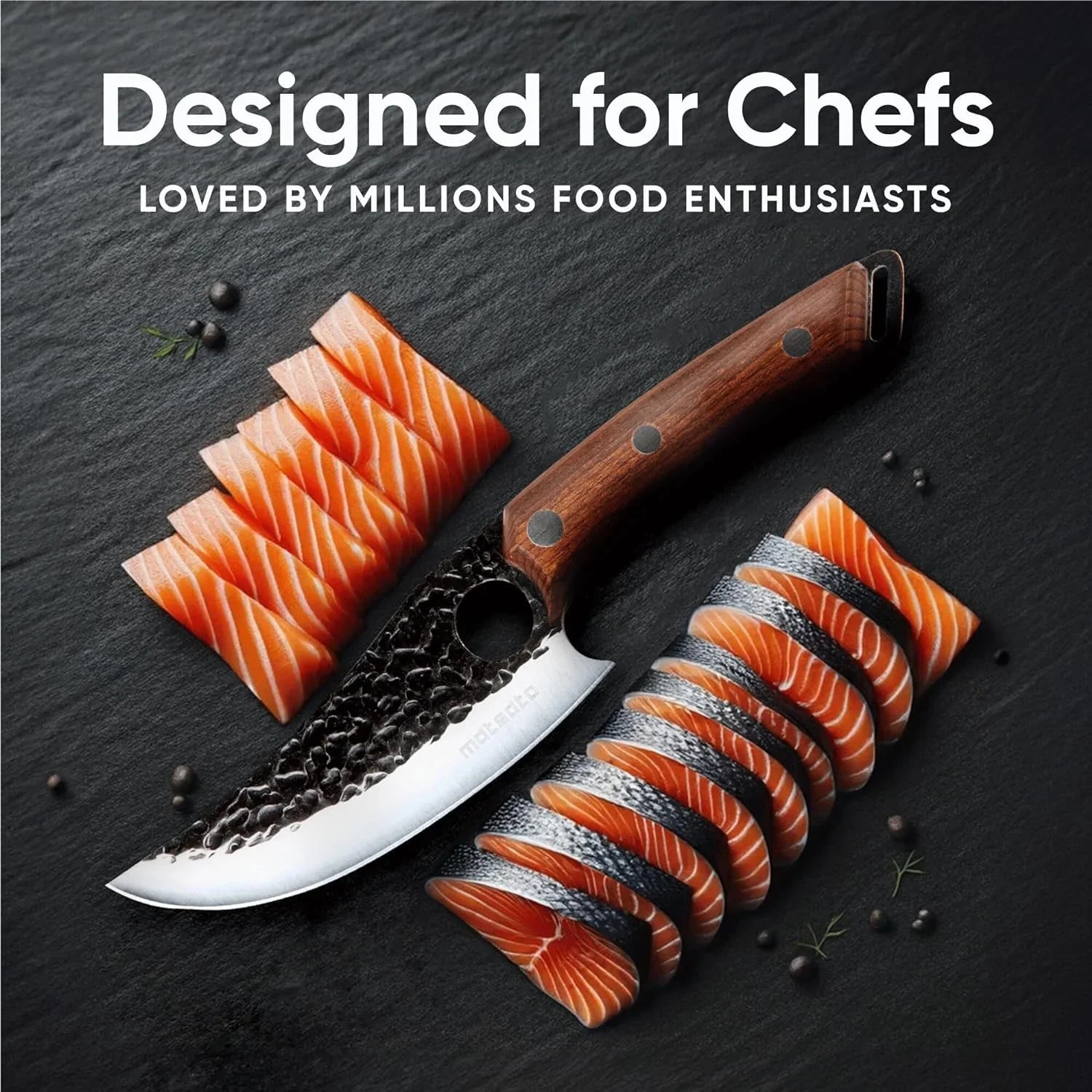 Japanese chef knife with wooden handle slicing fresh salmon on black slate surface