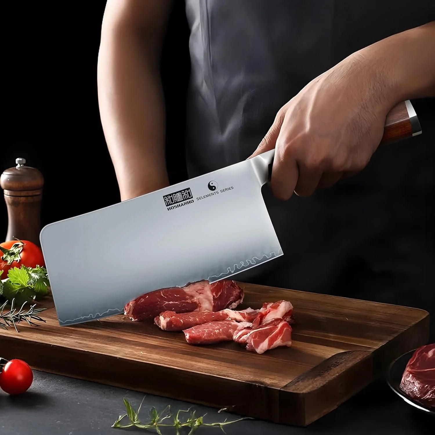 Hand holding Japanese 7-inch high carbon steel cleaver slicing raw meat on wooden cutting board