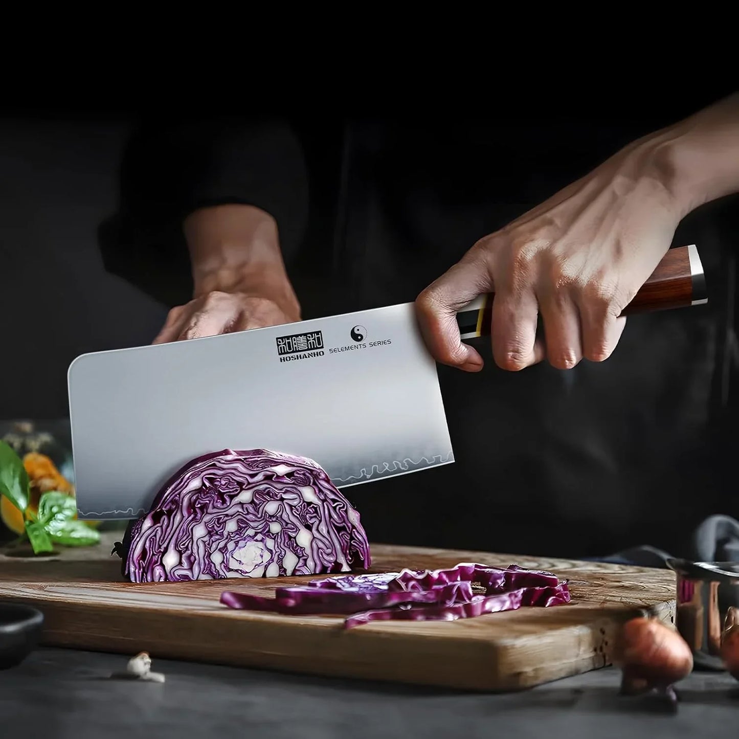 Hand slicing purple cabbage on wooden cutting board with 7-inch Japanese high carbon steel meat cleaver