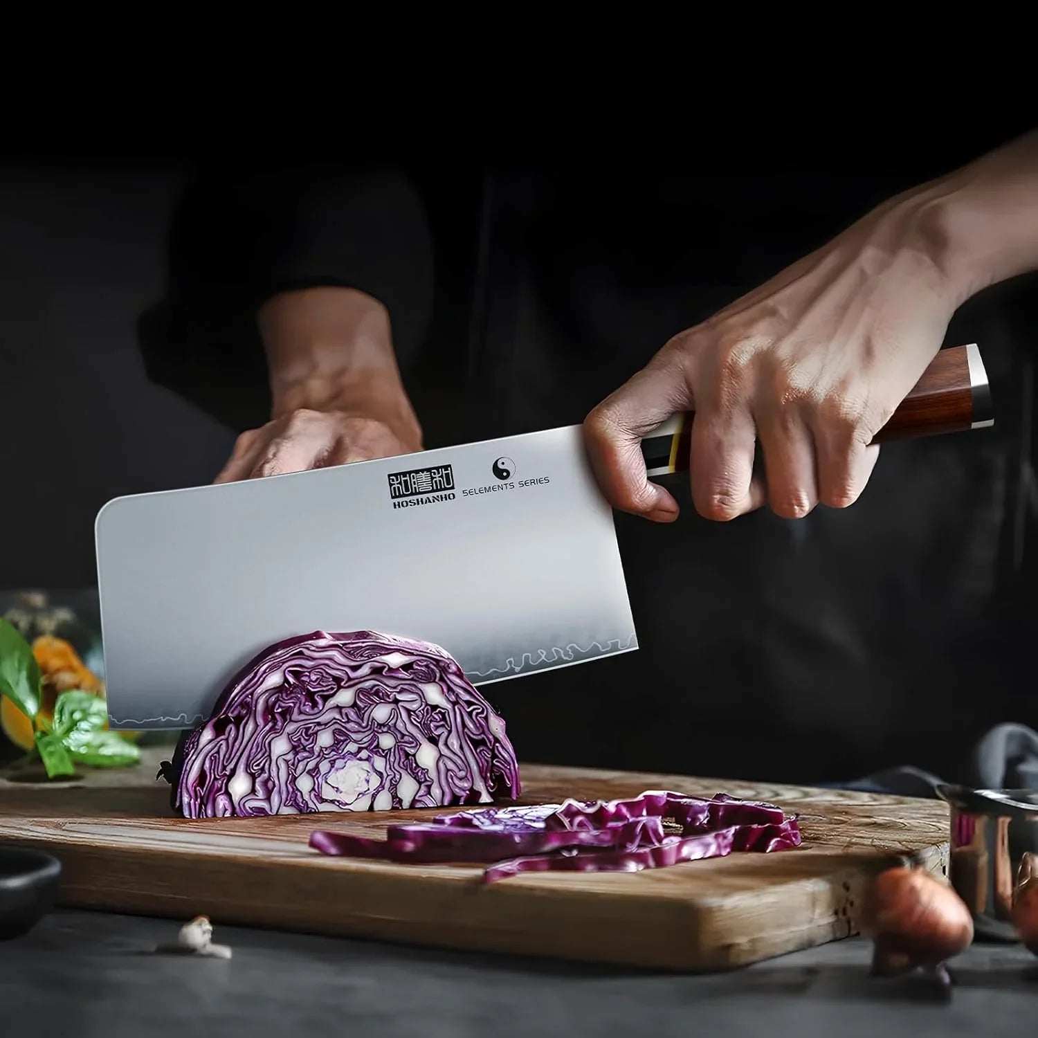 Hand slicing purple cabbage on wooden cutting board with 7-inch Japanese high carbon steel meat cleaver