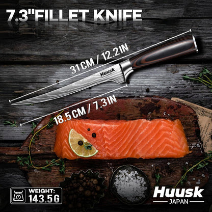7.3-inch fillet knife by Huusk Japan with wooden handle beside fresh salmon fillet on wooden board