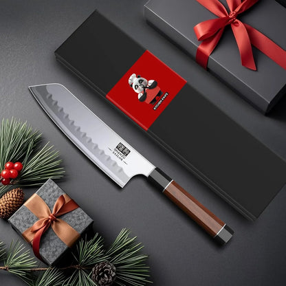 7-inch Japanese chef knife with wooden handle and wavy high-carbon steel blade near gift boxes