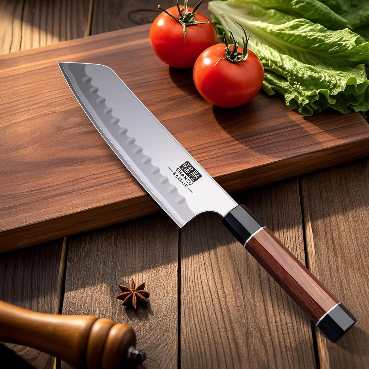 7-inch Japanese chef knife with wooden handle on cutting board with tomatoes and lettuce