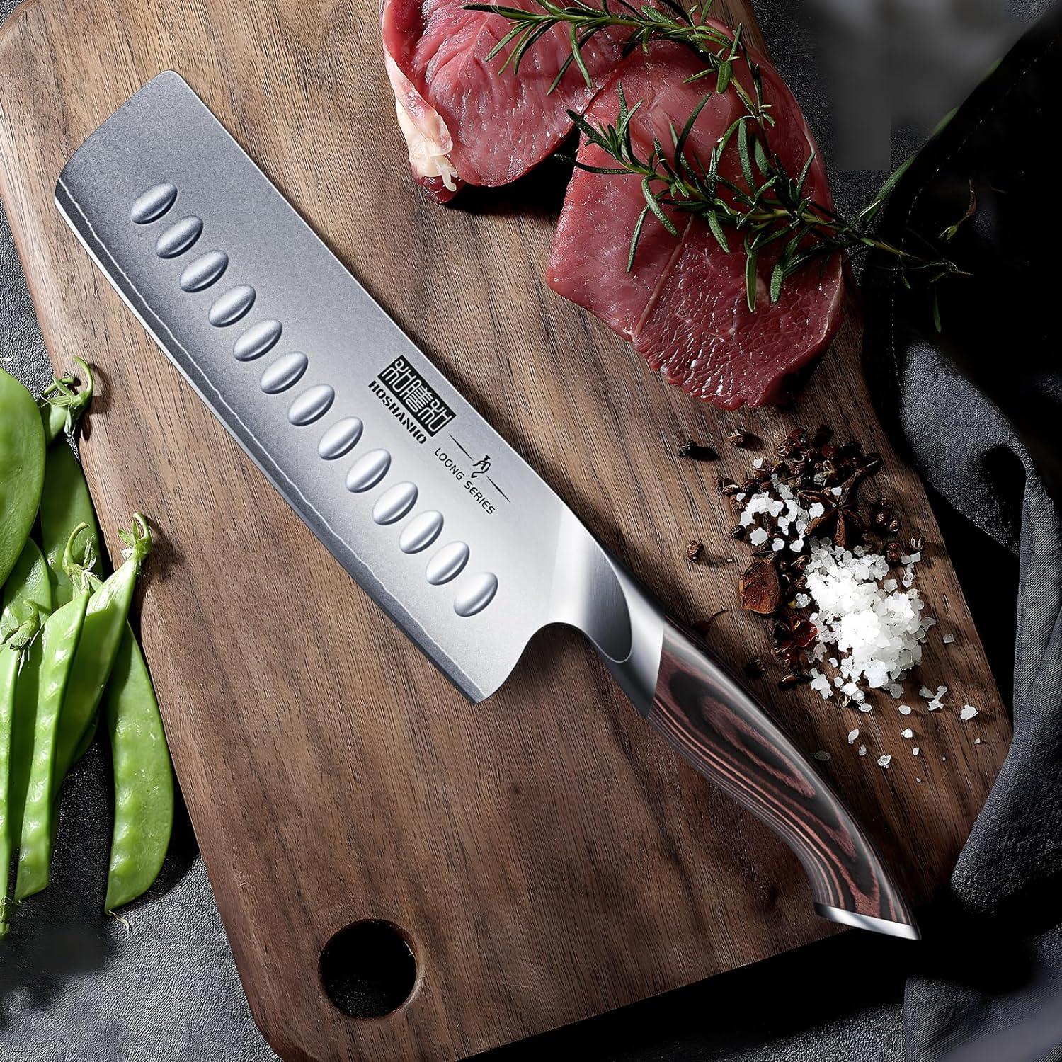 7-inch Japanese Nakiri knife with high carbon stainless steel blade on wooden cutting board with raw beef, rosemary, salt, and green peas