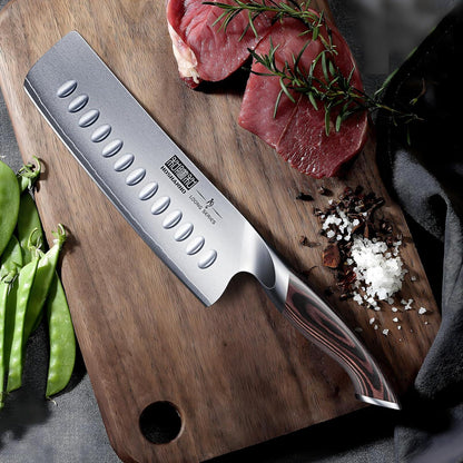 7-inch Japanese Nakiri knife with high carbon stainless steel blade on wooden cutting board with raw beef, rosemary, salt, and green peas