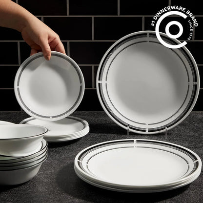 Brasserie 18-piece round white Vitrelle dinnerware set with black trim on dark textured surface