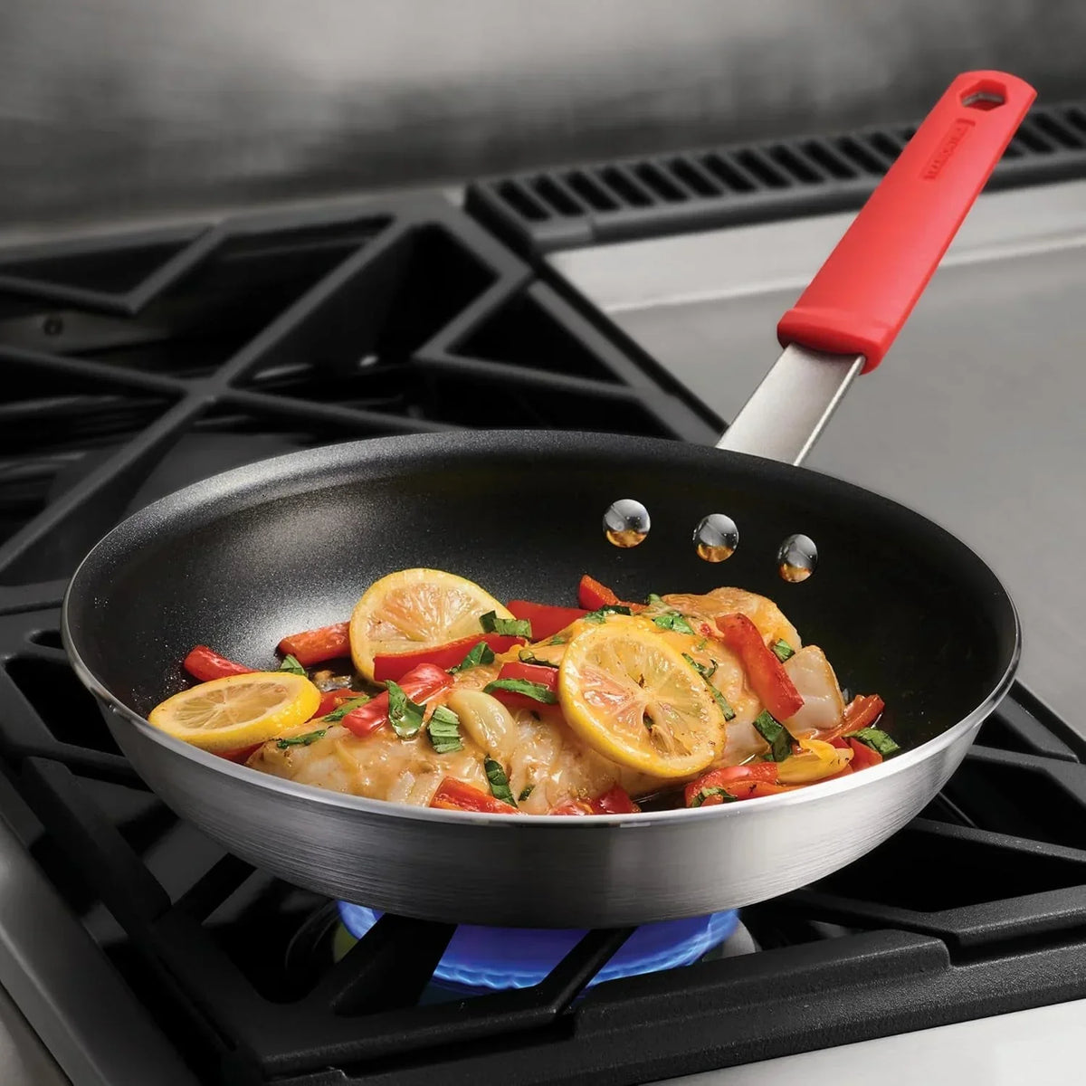 searing-chicken-with-lemon-slices-and-red-peppers-in-a-non-stick-skillet-on-a-gas-stove