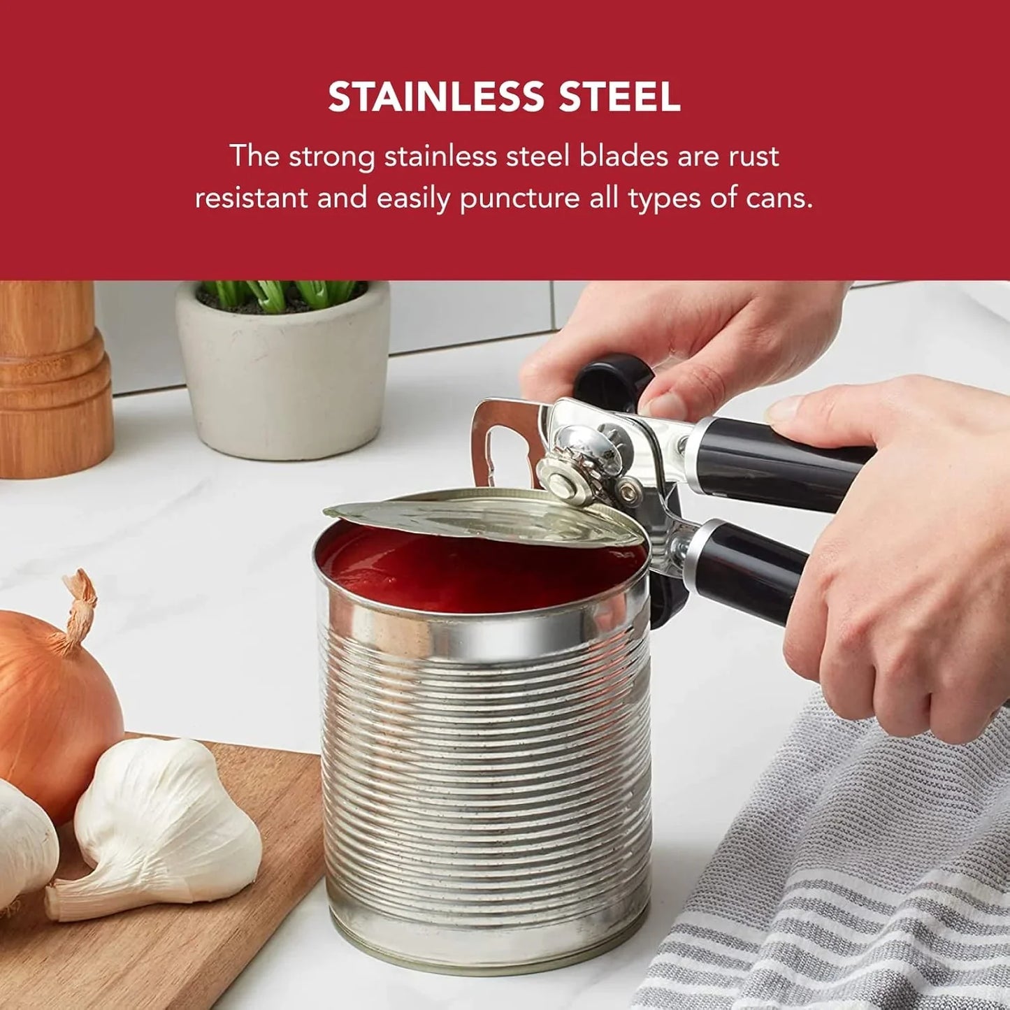 Hands using black-handled stainless steel can opener on an opened tin can with tomato sauce