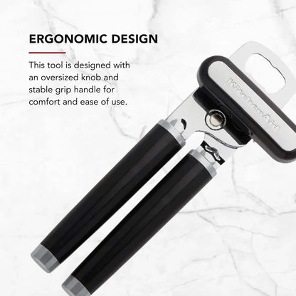 Black handle KitchenAid can and bottle opener with stainless steel cutting wheel on marble background