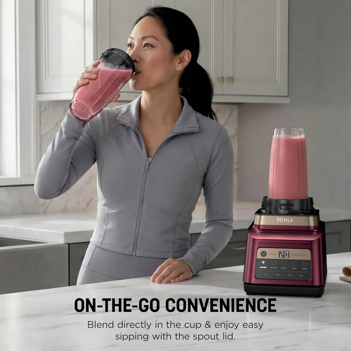 woman-drinking-a-smoothie-from-a-ninja-personal-blender-cup-in-a-modern-kitchen