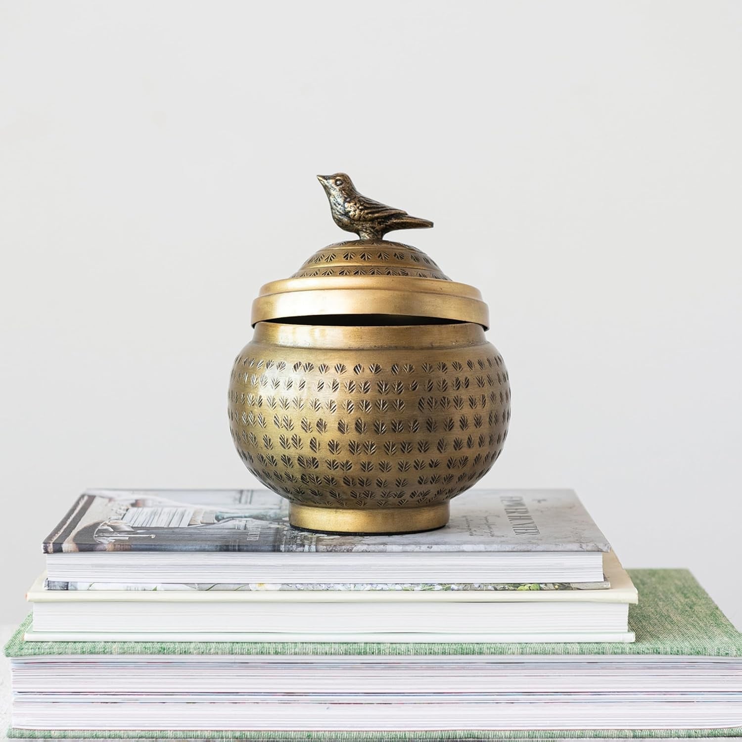 round-hammered-metal-container-with-bird-finial-brass-finish